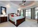 Spacious main bedroom featuring a tray ceiling, ceiling fan, and large windows with beautiful draperies at 1509 Churchill Downs Dr, Waxhaw, NC 28173