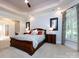 Main bedroom suite with tray ceilings, a sitting area, a large window, and plush carpet flooring at 1509 Churchill Downs Dr, Waxhaw, NC 28173
