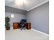 Well-lit office with neutral walls, built-in desk, and comfortable chair at 1509 Churchill Downs Dr, Waxhaw, NC 28173