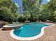 Inviting pool and jacuzzi surrounded by lush landscaping and lounge chairs at 1509 Churchill Downs Dr, Waxhaw, NC 28173