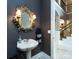 Chic powder room with decorative mirror, stylish vanity, and elegant sconces for a touch of luxury at 1509 Churchill Downs Dr, Waxhaw, NC 28173