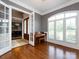 Bright sitting room with hardwood floors, large windows, and a view into the formal dining area at 1509 Churchill Downs Dr, Waxhaw, NC 28173