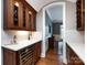 Convenient wet bar area with custom cabinetry, wine fridge, and stylish finishes for entertaining at 1509 Churchill Downs Dr, Waxhaw, NC 28173