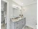 Beautiful bathroom with double sink vanity, granite countertop and custom cabinets, with a glass door shower at 1638 Wensley Dr, Charlotte, NC 28210