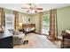 Inviting Bedroom with soft green walls, rocking horse, armchair and charming decor at 1638 Wensley Dr, Charlotte, NC 28210