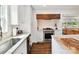 Bright kitchen featuring stainless steel appliances, marble countertops, and hardwood floors at 1638 Wensley Dr, Charlotte, NC 28210