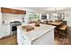 Kitchen island with seating, stainless steel appliances, and open layout at 1638 Wensley Dr, Charlotte, NC 28210
