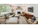 Cozy living room with a fireplace, plush seating, and abundant natural light at 1638 Wensley Dr, Charlotte, NC 28210