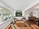 Bright living room featuring hardwood floors, built-in shelving, and comfortable seating at 1638 Wensley Dr, Charlotte, NC 28210