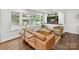 Cozy living room with large windows, built-in shelving, and hardwood floors at 1638 Wensley Dr, Charlotte, NC 28210