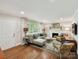Bright living room featuring hardwood floors, fireplace and large windows at 1638 Wensley Dr, Charlotte, NC 28210