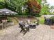 Outdoor patio featuring a fire pit, seating, and lush landscaping for relaxing and entertaining at 1638 Wensley Dr, Charlotte, NC 28210