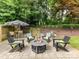 Outdoor patio featuring a fire pit, seating, and lush landscaping for relaxing and entertaining at 1638 Wensley Dr, Charlotte, NC 28210