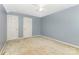 Bedroom with carpet, two doors, ceiling fan, and blue walls offers a peaceful retreat at 1750 Trellis Dr, Rock Hill, SC 29732