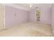 Comfortable bedroom with lilac-colored walls, neutral carpet, a window with curtains, and a ceiling fan at 1750 Trellis Dr, Rock Hill, SC 29732
