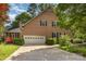 Charming brick home featuring an attached garage, driveway, and mature landscaping at 1750 Trellis Dr, Rock Hill, SC 29732
