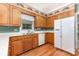 Traditional kitchen with wooden cabinets, white appliances, and a window over the sink at 1750 Trellis Dr, Rock Hill, SC 29732