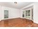 Living room featuring large windows with shutters and beautiful hardwood floors at 1750 Trellis Dr, Rock Hill, SC 29732