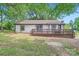 Back of house with small deck overlooks spacious tree-lined backyard at 2009 Pinevalley Rd, Rock Hill, SC 29732