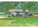 Charming single-story home with a well-maintained lawn, complemented by mature trees for shade at 2009 Pinevalley Rd, Rock Hill, SC 29732