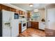 Well-lit kitchen with wood cabinets, updated appliances, and wood-look flooring at 2009 Pinevalley Rd, Rock Hill, SC 29732