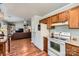 Kitchen showcasing wood cabinets and stainless steel appliances adjacent to open living area at 2009 Pinevalley Rd, Rock Hill, SC 29732