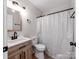 Bathroom featuring a decorative mirror, shower with curtain and wood-look vanity at 2040 Stratford Dr, Conover, NC 28613