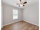 This bedroom has wood-look floors, base molding and a window at 2040 Stratford Dr, Conover, NC 28613