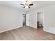 Neutral bedroom featuring a ceiling fan, wood-look flooring and an ensuite bathroom at 2040 Stratford Dr, Conover, NC 28613