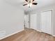 Neutral bedroom features a ceiling fan, wood-look flooring and closet space at 2040 Stratford Dr, Conover, NC 28613