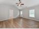 Light-filled bedroom with vaulted ceilings, neutral paint, and wood-look flooring at 2040 Stratford Dr, Conover, NC 28613