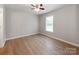 This bedroom has a ceiling fan, wood-look flooring and a window for natural light at 2040 Stratford Dr, Conover, NC 28613
