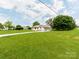 Sprawling lawn surrounds single-story home with attached carport and paved driveway at 2040 Stratford Dr, Conover, NC 28613