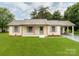 Charming single-story home with a manicured lawn, painted brick, and a covered front porch at 2040 Stratford Dr, Conover, NC 28613