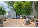Spacious backyard with a gray shed, surrounded by mature trees providing ample shade at 2217 Tate St, Charlotte, NC 28216
