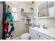 Bathroom featuring a toilet, sink, vanity, mirror, and shelves for toiletries with a tiled shower at 2217 Tate St, Charlotte, NC 28216