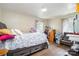 A bedroom with hardwood floors, two windows with curtains, and a comfortable bed at 2217 Tate St, Charlotte, NC 28216