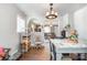 A dining room area with hardwood floors and view to a living room with an open floor plan and natural light at 2217 Tate St, Charlotte, NC 28216