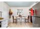 Kitchen area with a small table and chairs, tile floor, and stainless-steel refrigerator at 2217 Tate St, Charlotte, NC 28216