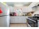 Traditional kitchen with white cabinets, tiled floor, and a window providing natural light over the kitchen sink at 2217 Tate St, Charlotte, NC 28216