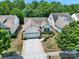 A bird's-eye view of a beautifully landscaped home nestled among mature trees in a quiet neighborhood at 2224 Hartwell Ln, Fort Mill, SC 29707