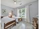 Cozy bedroom featuring two twin beds, bright windows, and wood flooring at 2224 Hartwell Ln, Fort Mill, SC 29707