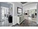 Inviting entryway featuring slate tile floors, decorative mirror, and arched doorway leading into the living area at 2224 Hartwell Ln, Fort Mill, SC 29707