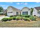Charming home featuring a well-manicured lawn with flowerbeds and a driveway leading to an attached garage at 2224 Hartwell Ln, Fort Mill, SC 29707