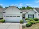 Charming home showcasing a lush, well-manicured yard and a two-car garage, all under a clear blue sky at 2224 Hartwell Ln, Fort Mill, SC 29707