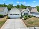 Beautiful single-Gathering home with an attached garage, lush lawn, and a well-maintained driveway at 2224 Hartwell Ln, Fort Mill, SC 29707