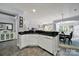 Kitchen area with white cabinets, stainless steel appliances, and black countertops open to the dining area at 2224 Hartwell Ln, Fort Mill, SC 29707