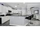 Kitchen featuring white cabinets, black countertops, stainless steel appliances, and a breakfast bar with seating at 2224 Hartwell Ln, Fort Mill, SC 29707
