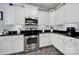 Kitchen with stainless steel oven and microwave, white subway tile backsplash, and black countertops at 2224 Hartwell Ln, Fort Mill, SC 29707