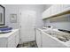 Functional laundry room equipped with a sink, cabinetry, and modern appliances at 2224 Hartwell Ln, Fort Mill, SC 29707